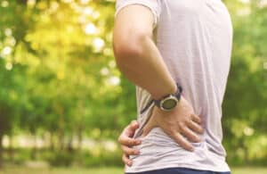 Man holding his lower back and hip in pain